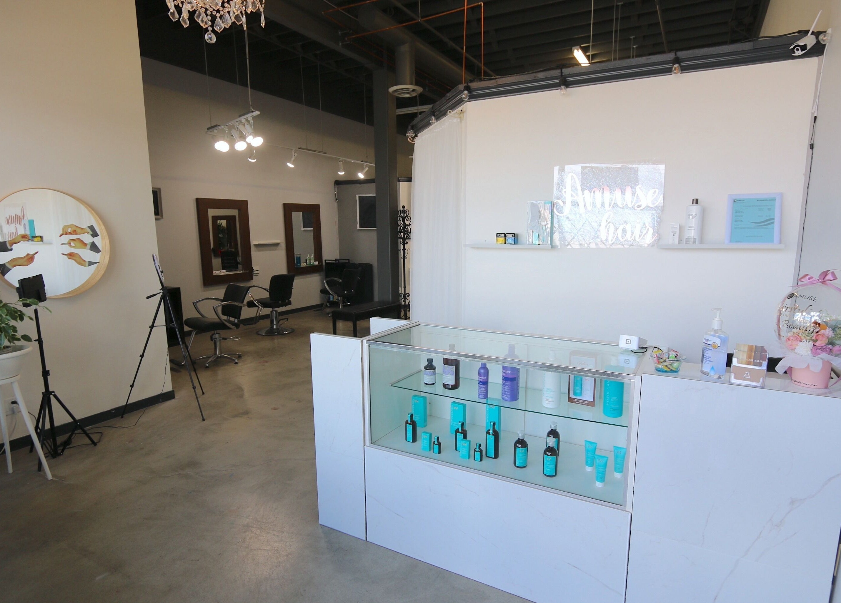 Amuse Hair and Nail Salon's chic interior in Langley City, British Columbia, CA features stylish chairs and products.