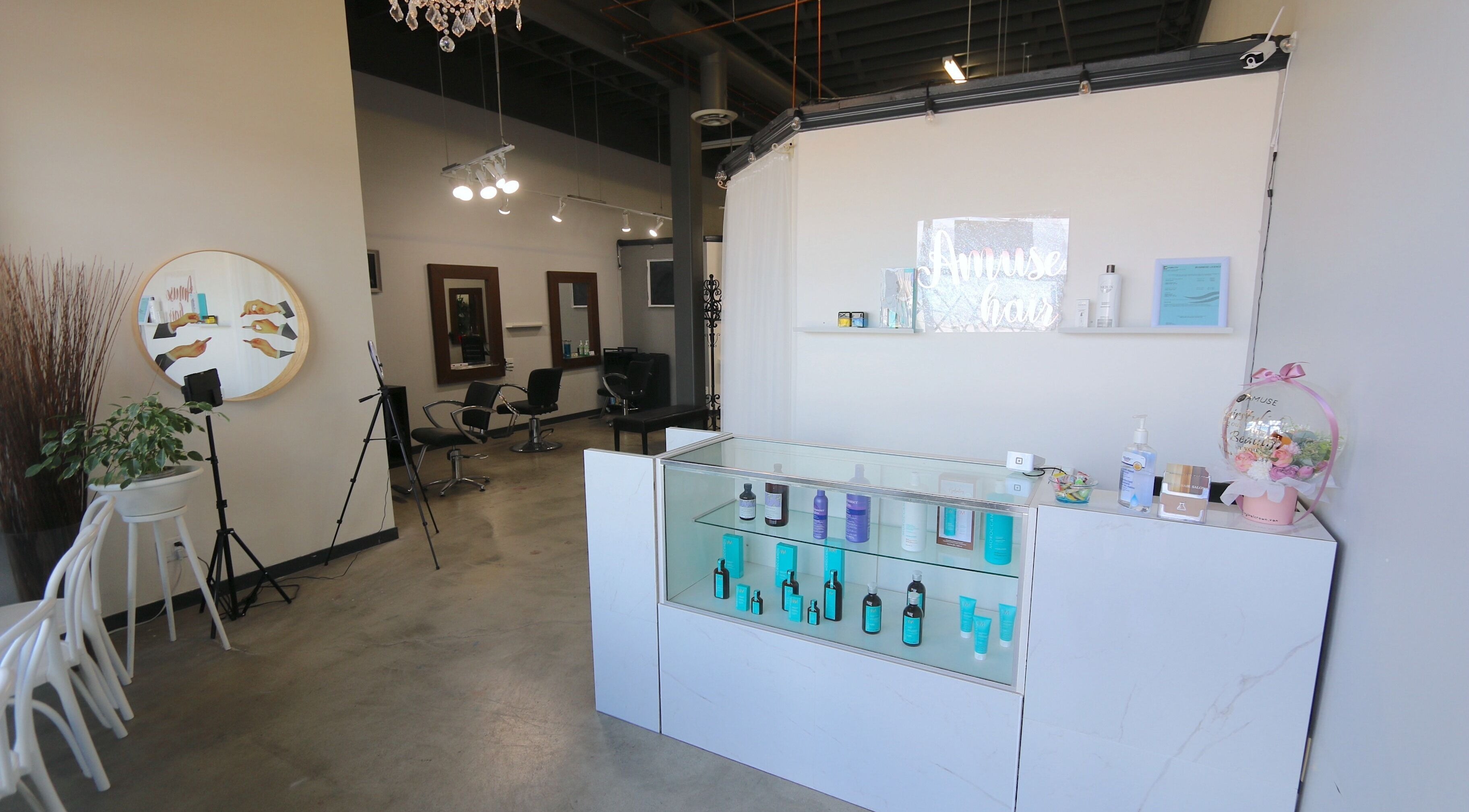 Amuse Hair and Nail Salon's chic interior in Langley City, British Columbia, CA features stylish chairs and products.
