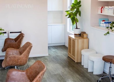 Stylish salon seating at AoifeMariehairartistry, Brisbane, Queensland, AU with plants and sleek decor.
