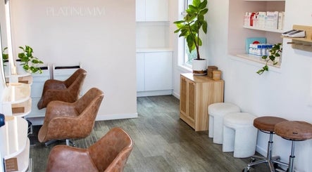Stylish salon seating at AoifeMariehairartistry, Brisbane, Queensland, AU with plants and sleek decor.