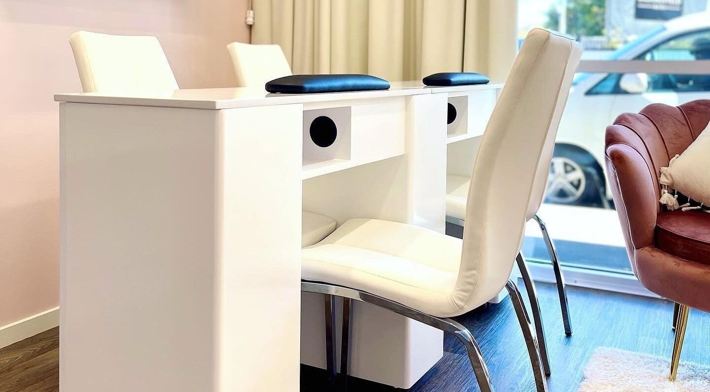 Bright nail salon area at Glowing Goddess Beauty, Christchurch, Canterbury, NZ with modern white seating.