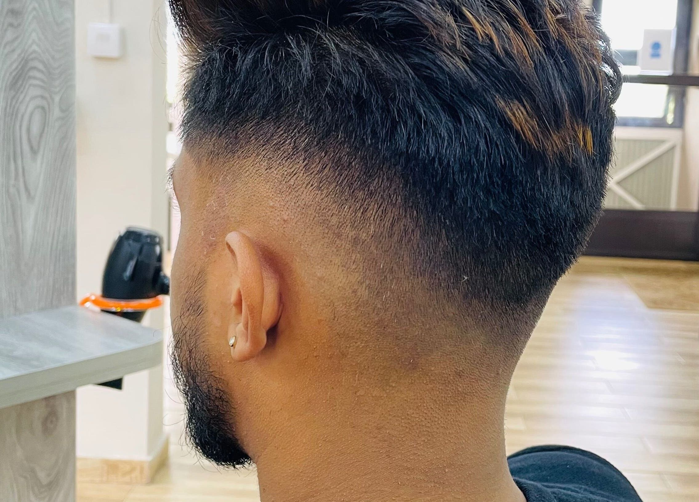 Modern fade haircut at Waz Hair Care, Grand Port, MU, showcasing sleek barbering skills.