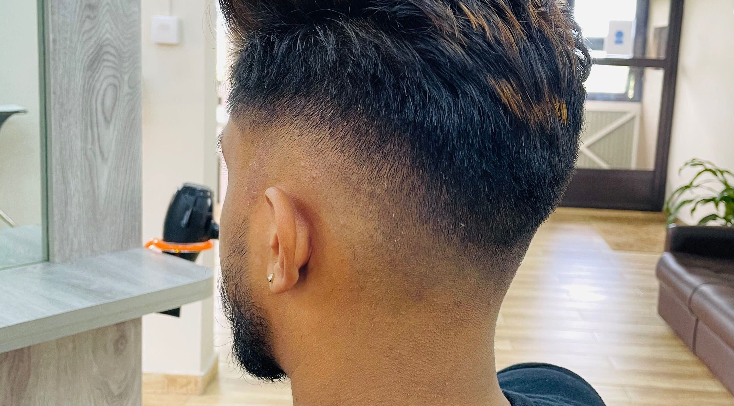 Modern fade haircut at Waz Hair Care, Grand Port, MU, showcasing sleek barbering skills.