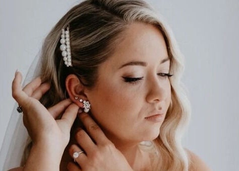 Bride adjusts earrings at Labelleame Aesthetics, Corindi Beach, New South Wales, AU.