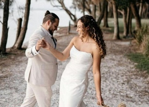 Happy couple dancing at Labelleame Aesthetics, Corindi Beach, New South Wales, AU amid scenic natural beauty.