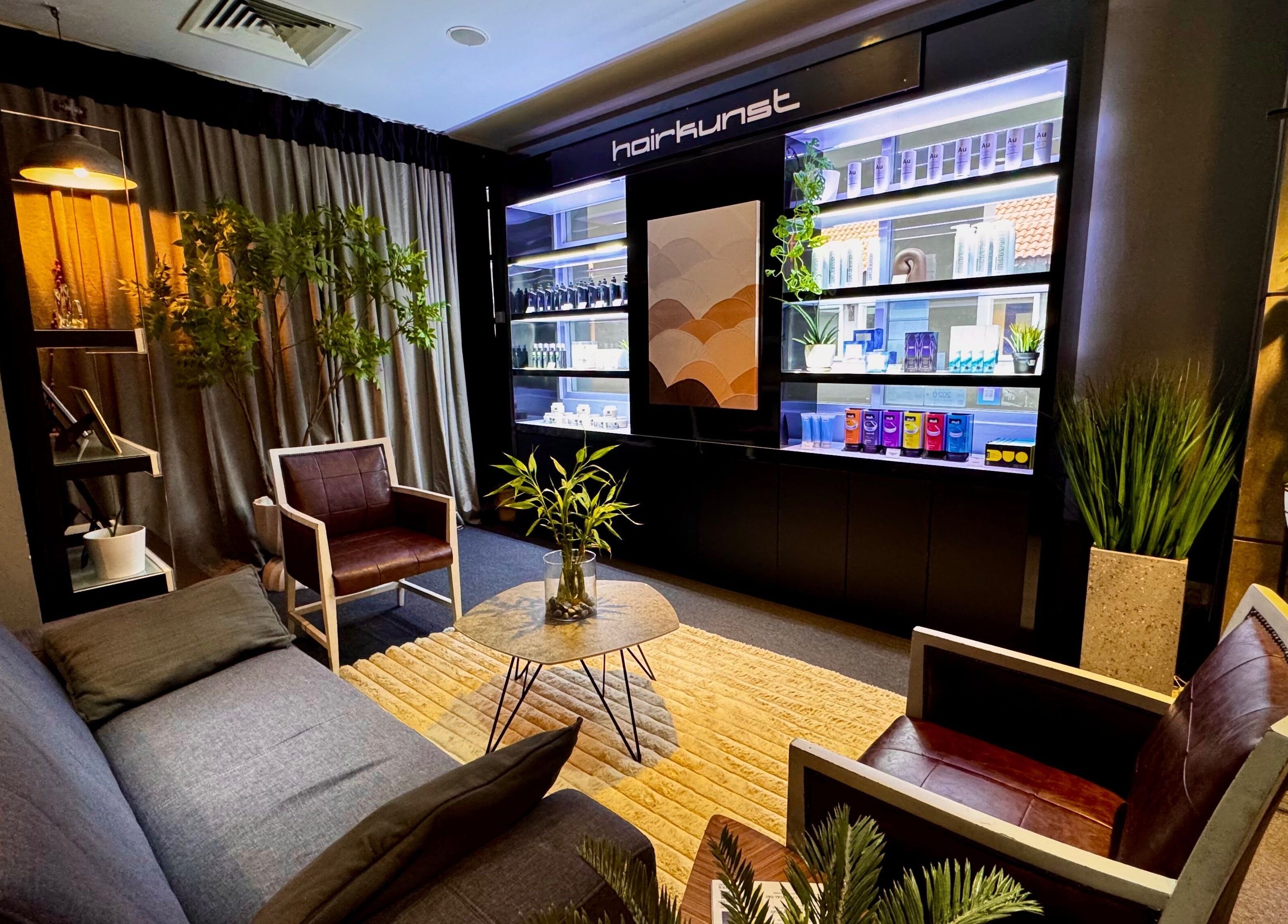 Relaxing lounge at Hairkunst Premium Salon, Petaling Jaya, Selangor, MY. Modern decor with plants and seating.