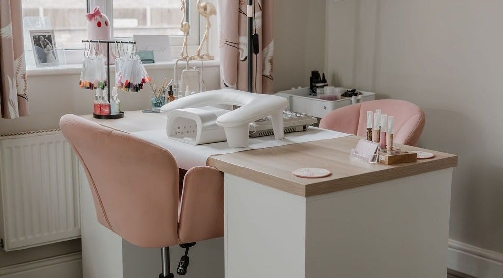 Elegant nail station at AbiLou Beauty, Stowmarket, England, GB featuring pink chairs and manicure tools.