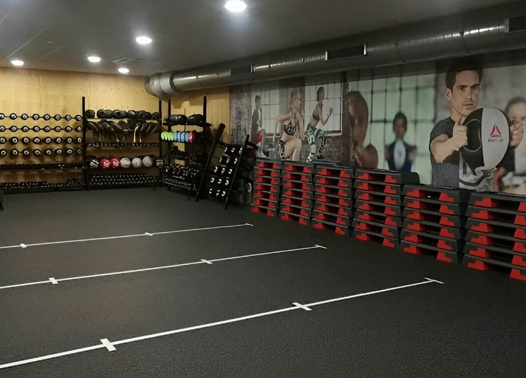 Direct Gainz gym room with equipment in Birmingham, England, GB, featuring weights and exercise gear.
