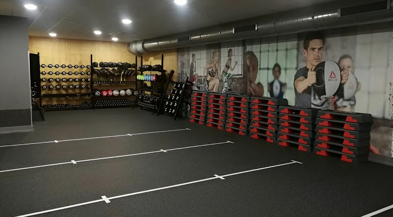 Direct Gainz gym room with equipment in Birmingham, England, GB, featuring weights and exercise gear.