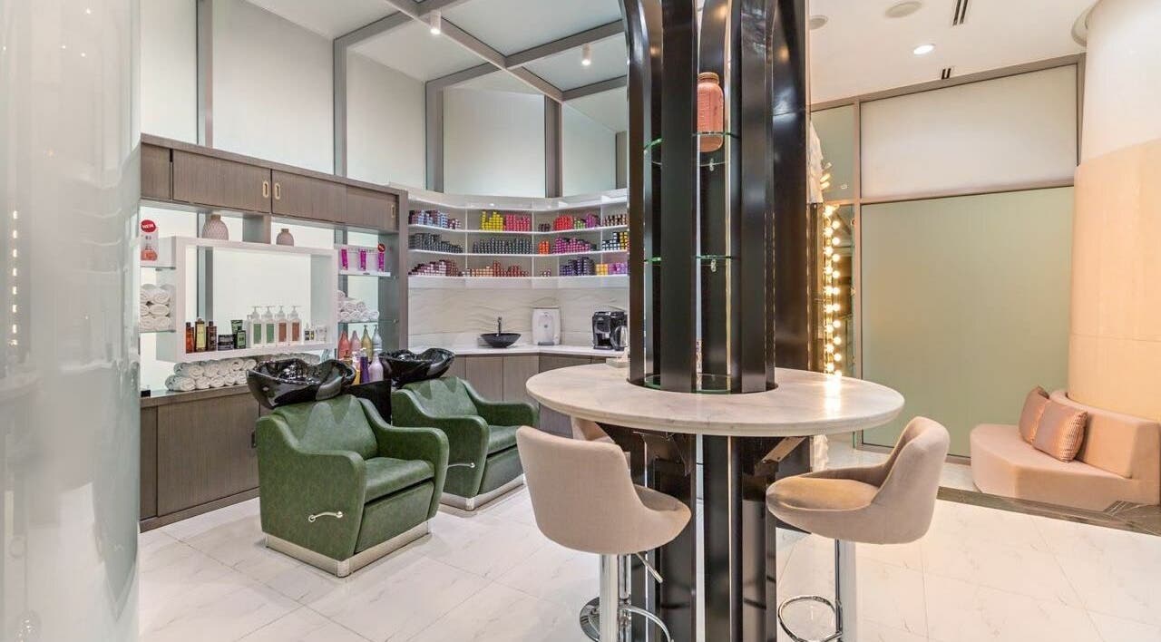 Modern beauty setup at Ricci Capricci, Dubai. Luxurious salon with stylish chairs and shelves full of products.
