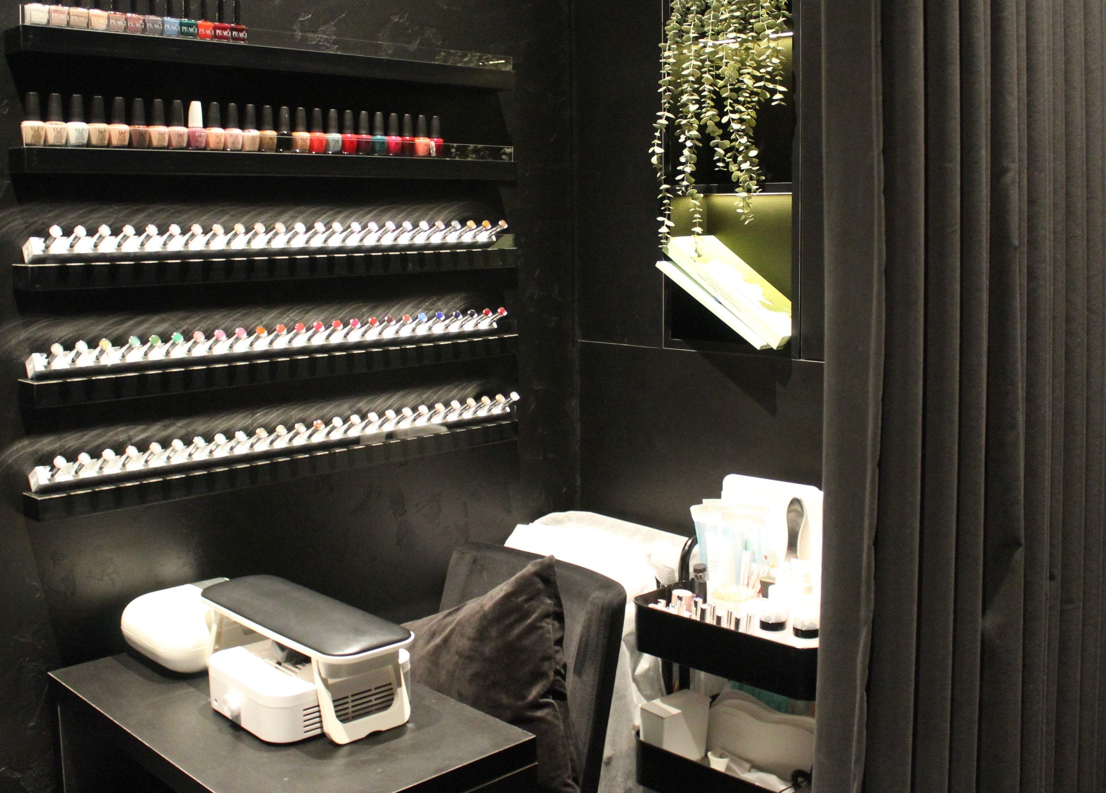 Modern nail care station at Aqua Face Facial Bar, Dubai, Dubai, AE featuring stylish polish display.