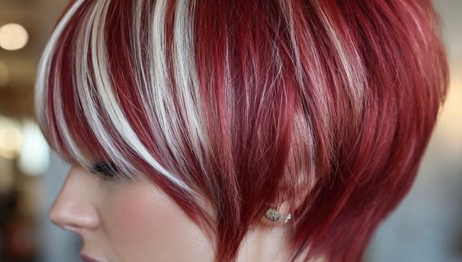 Vibrant red bob hairstyle with highlights at Hair Muse, Pretoria, Gauteng, ZA.