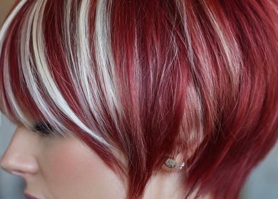 Vibrant red bob hairstyle with highlights at Hair Muse, Pretoria, Gauteng, ZA.