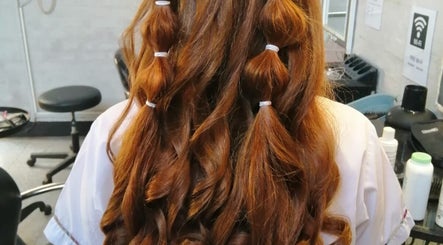 Long, styled curls at Hair Muse, Pretoria, Gauteng, ZA, showcasing intricate hair design.