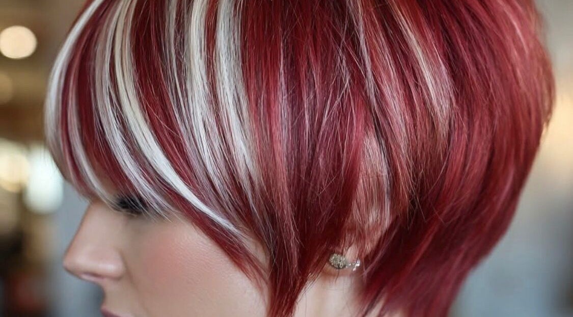 Close-up of stylish red and blonde striped hairstyle at Hair Muse in Pretoria, Gauteng, ZA.