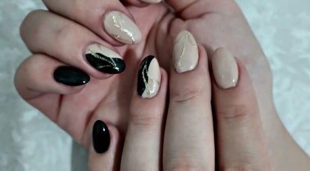 Chic nail art design at Royal Beauty, Bloemfontein, Free State, ZA, featuring black and nude shades.