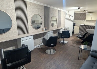 Contemporary interior of Amara's Hair Lounge in Exning, England, GB showcasing stylish salon chairs and mirrors.
