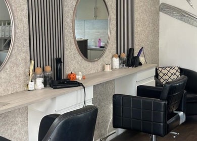 Modern salon setup at Amara's Hair Lounge, Exning, England, GB, featuring stylish chairs and mirrors.