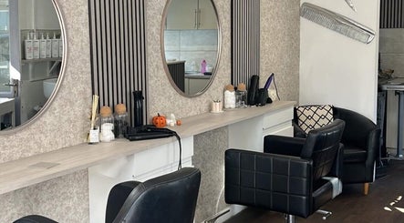 Modern salon setup at Amara's Hair Lounge, Exning, England, GB, featuring stylish chairs and mirrors.