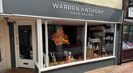 Front view of Warren Anthony Hair Salon in Gosport, England, GB with stylish window display.
