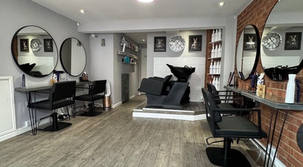 Modern interior of Warren Anthony Hair Salon in Gosport, England, GB with stylish stations and decor.