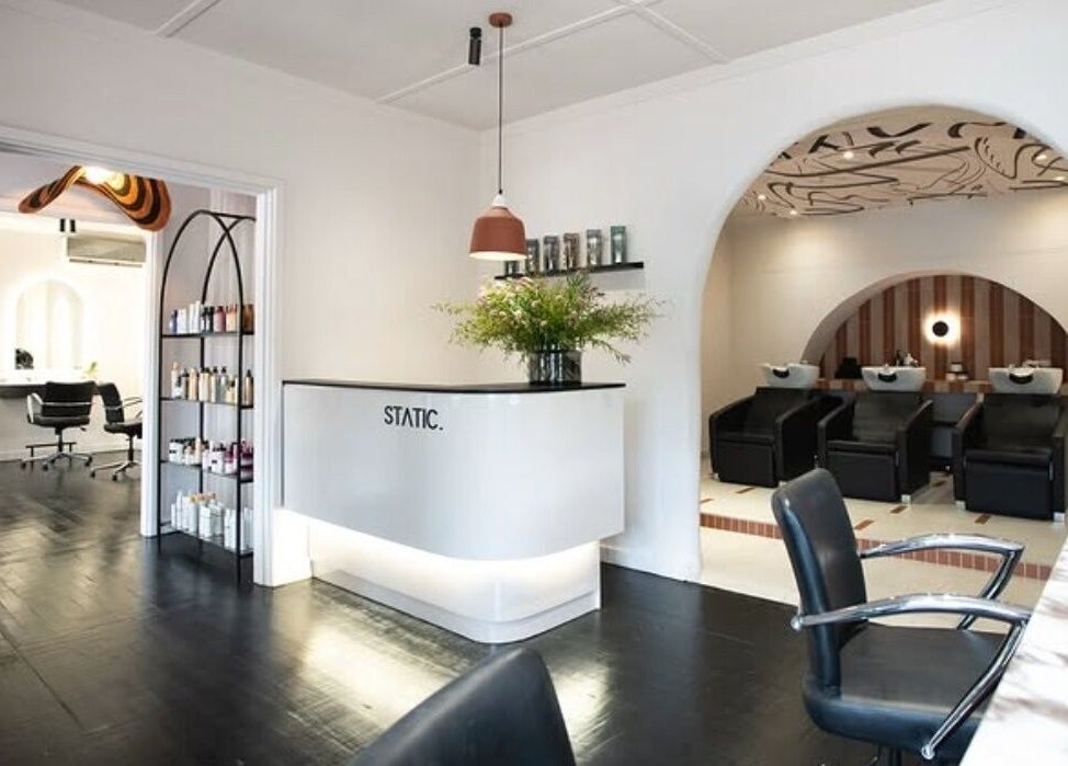 Interior of STATIC Dry Bar in Durban North, Kwazulu-natal, ZA with sleek salon stations and modern decor.