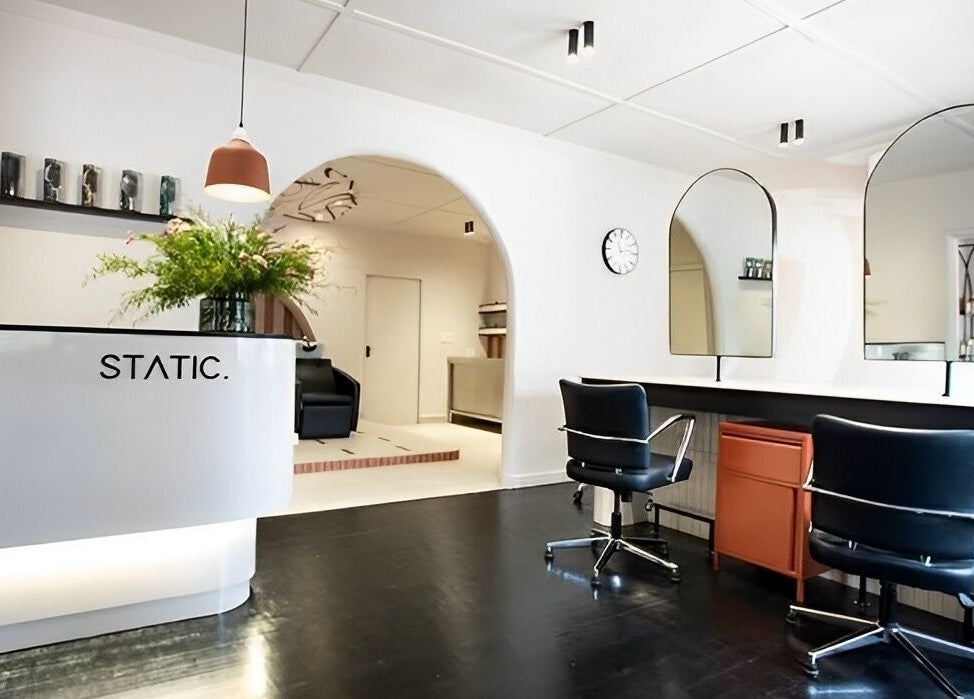 Modern interior of STATIC Dry Bar in Durban North, Kwazulu-natal, ZA with sleek chairs and mirrors.