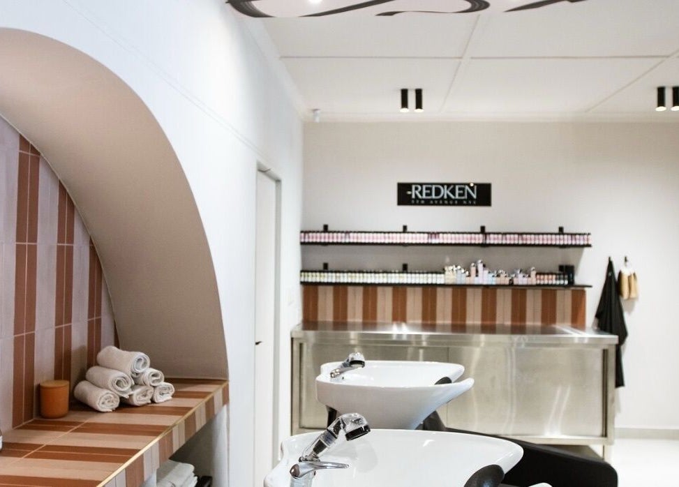 Modern salon interior at STATIC Dry Bar, Durban North, Kwazulu-natal, ZA with stylish wash stations and products.