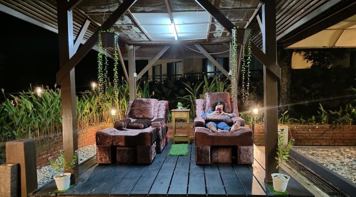 Cozy lounge area at night in Impiana Kuantan, Kuantan, Pahang, MY, featuring plush chairs and lush greenery.