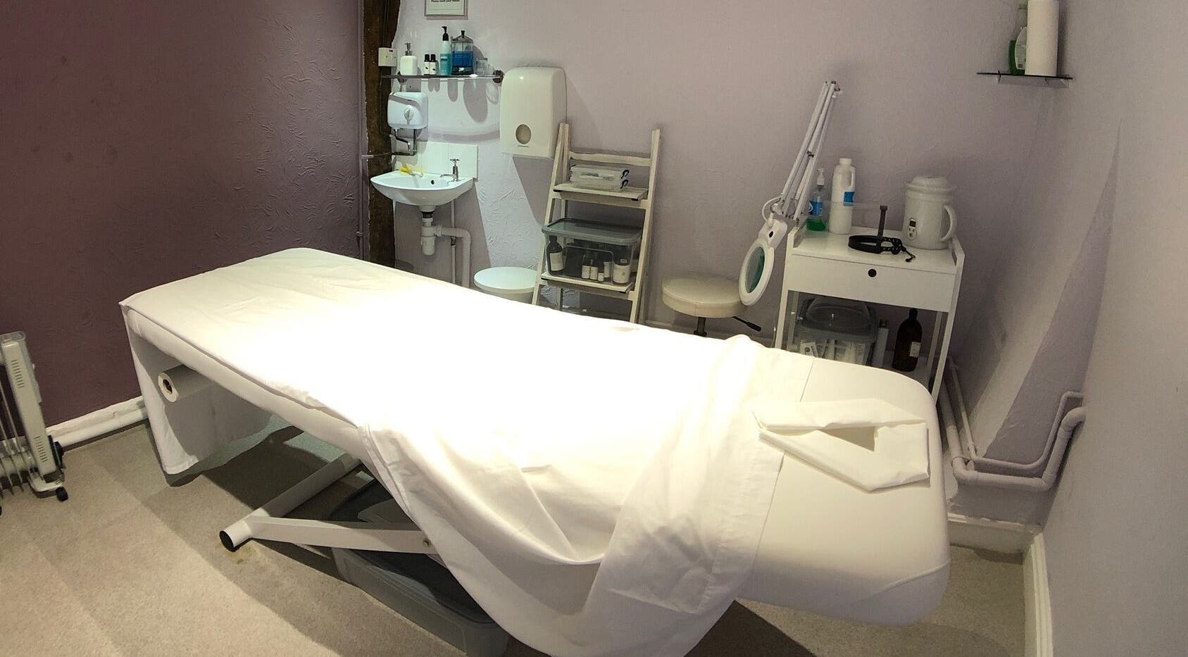 Spa treatment room at The Body Sanctuary, Bury Saint Edmunds, England, GB, featuring a cozy massage table.