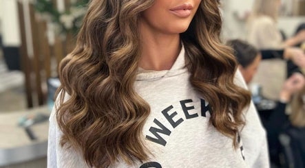 Woman with glam wavy hairstyle at De La Mare in North Lanarkshire, UK, GB salon setting.