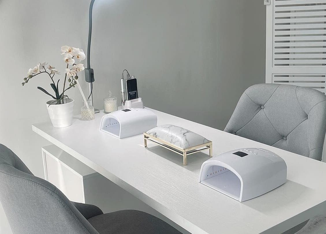 Modern nail treatment area at Lash L'amour in Whangaparāoa, Auckland, NZ with chic decor and equipment.