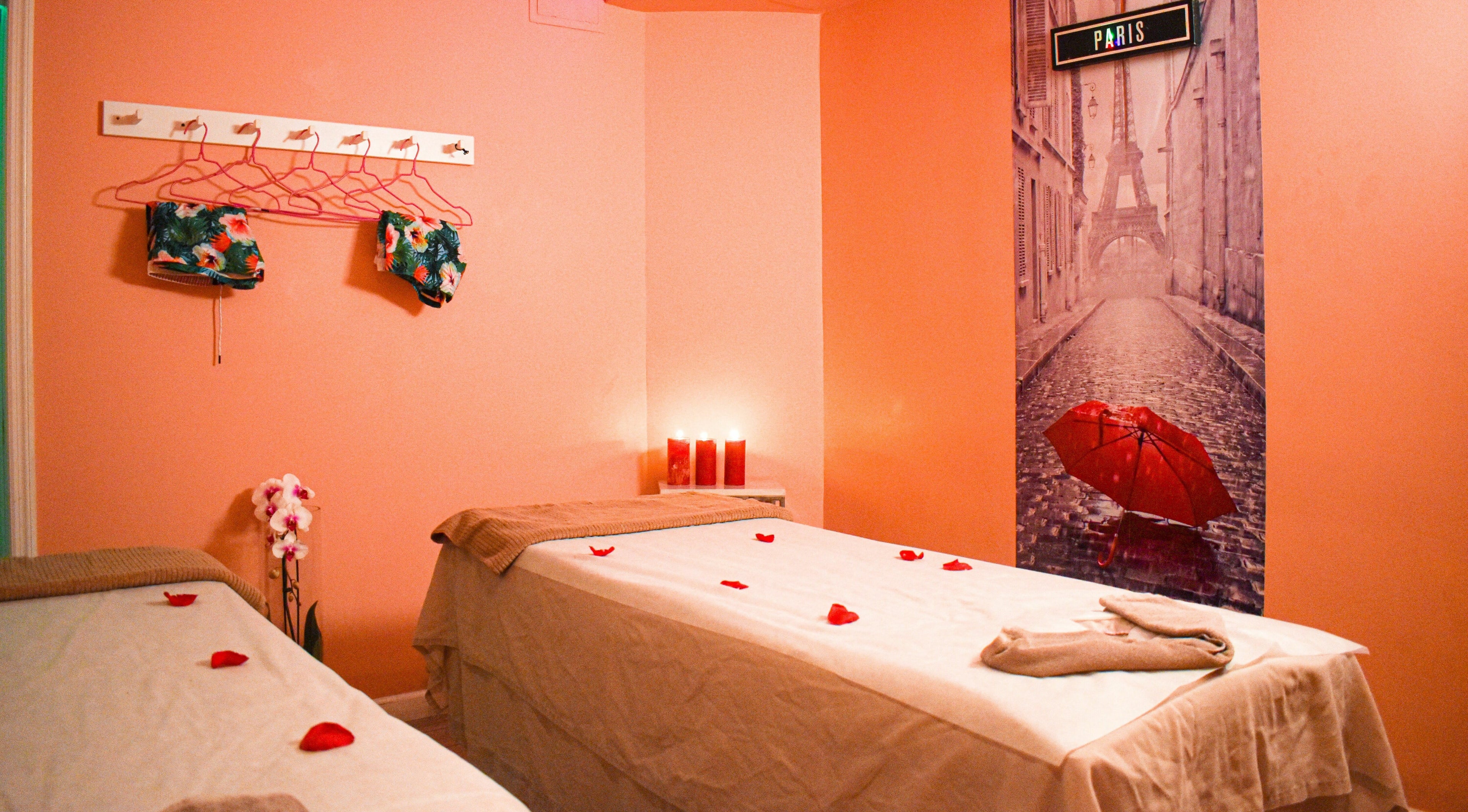 Relaxing spa room at The Couple Spa in New York, New York, US with warm lighting and rose petals.
