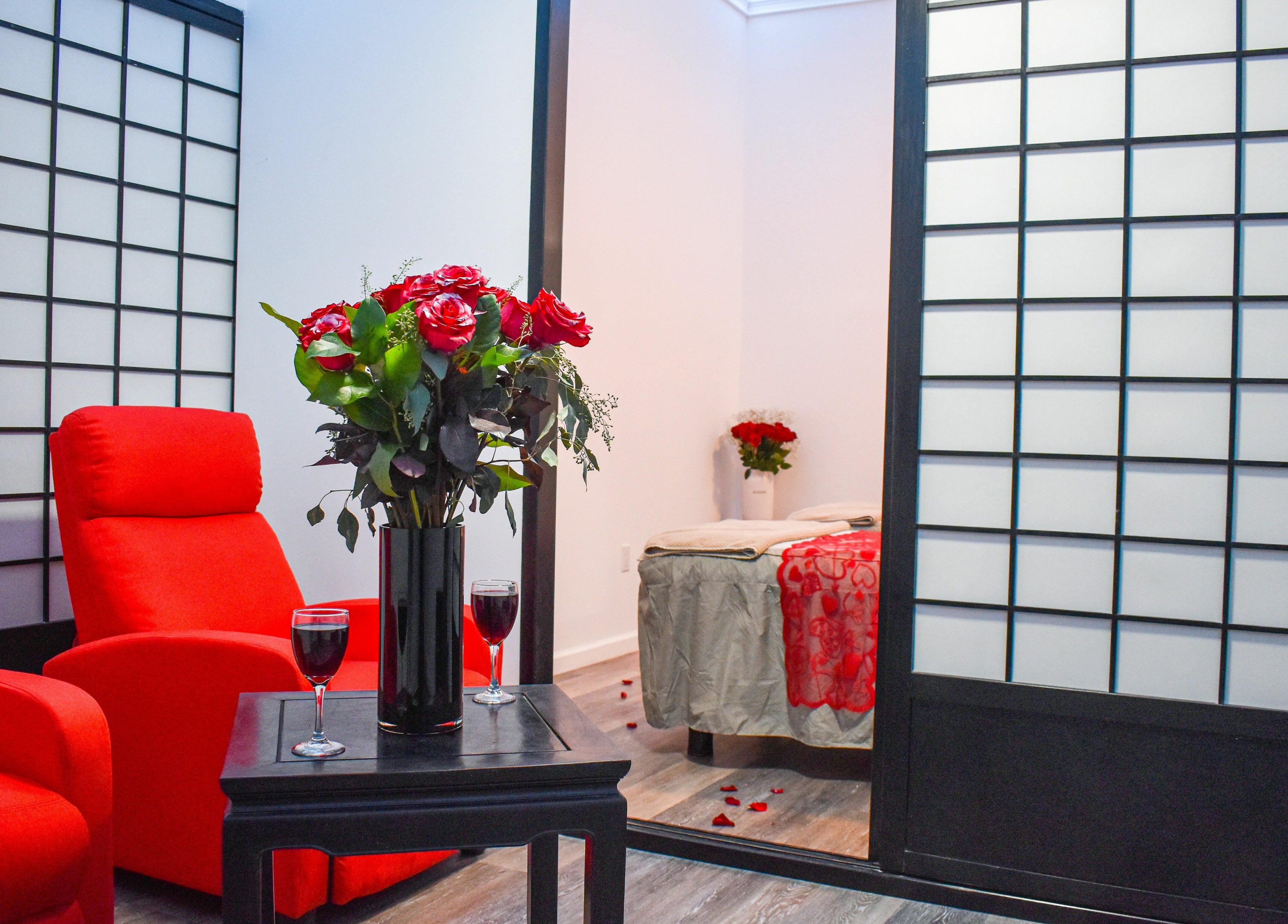 Relaxing red lounge and massage area at The Couple Spa, New York, New York, US with elegant decor.