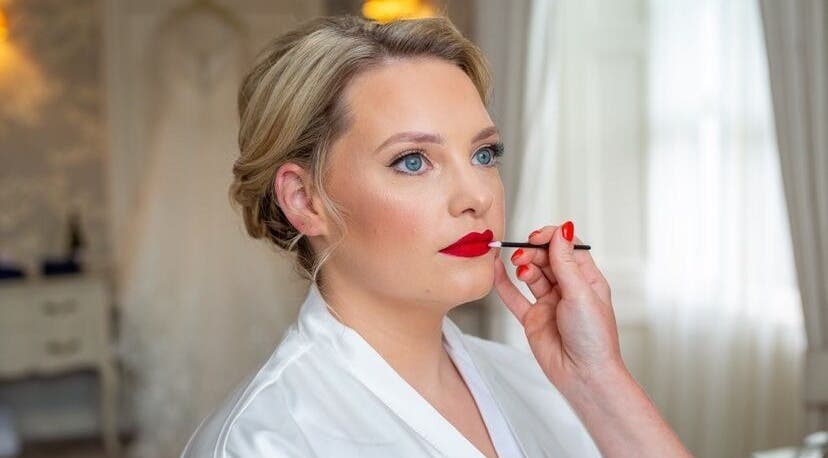 Makeup artist applying red lipstick at Shawndelle Scott Make Up Artistry in Musselburgh, Scotland, GB.