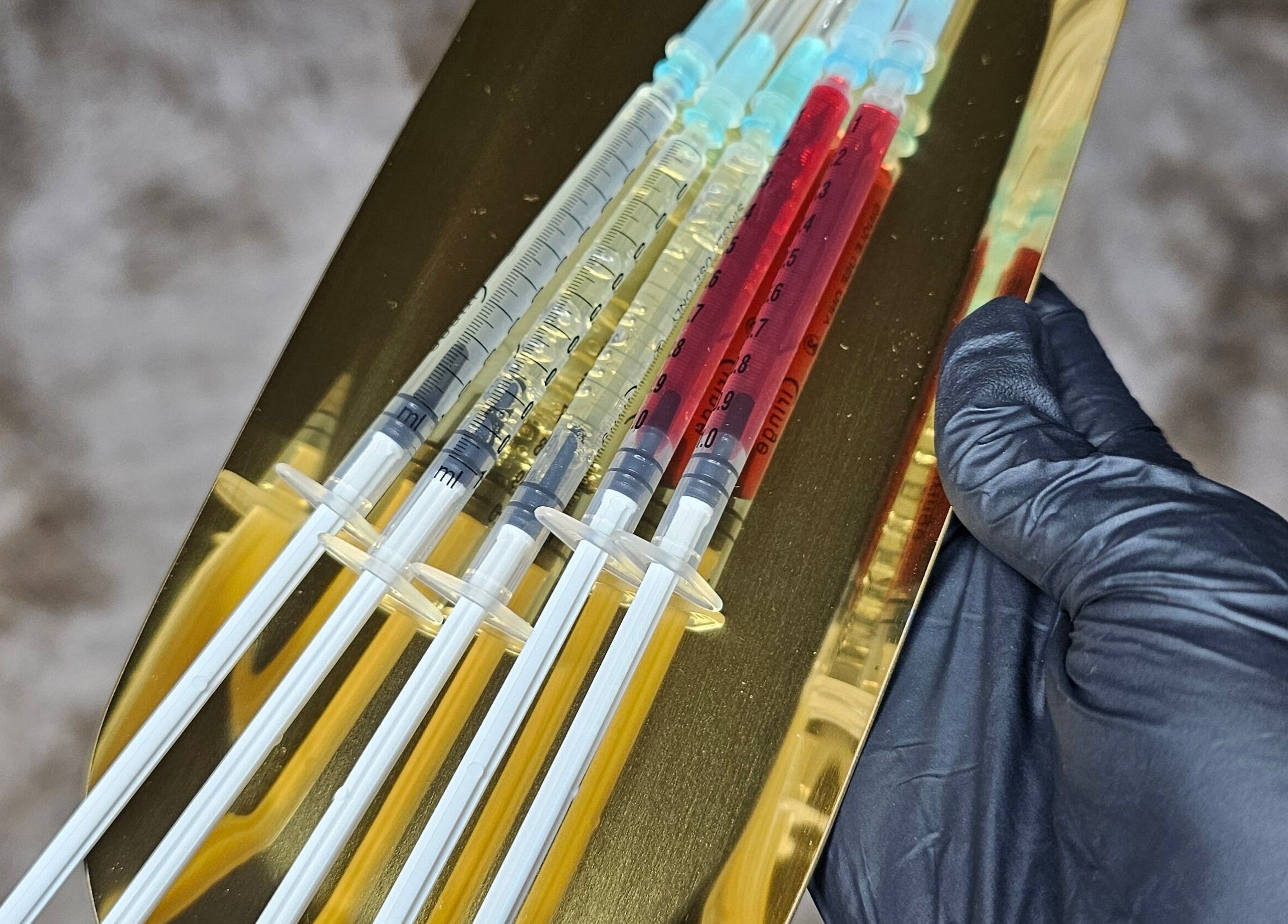 Elegant syringes on a tray at Glass Skin Studio, Glasgow, Scotland, GB, showcasing skincare precision.