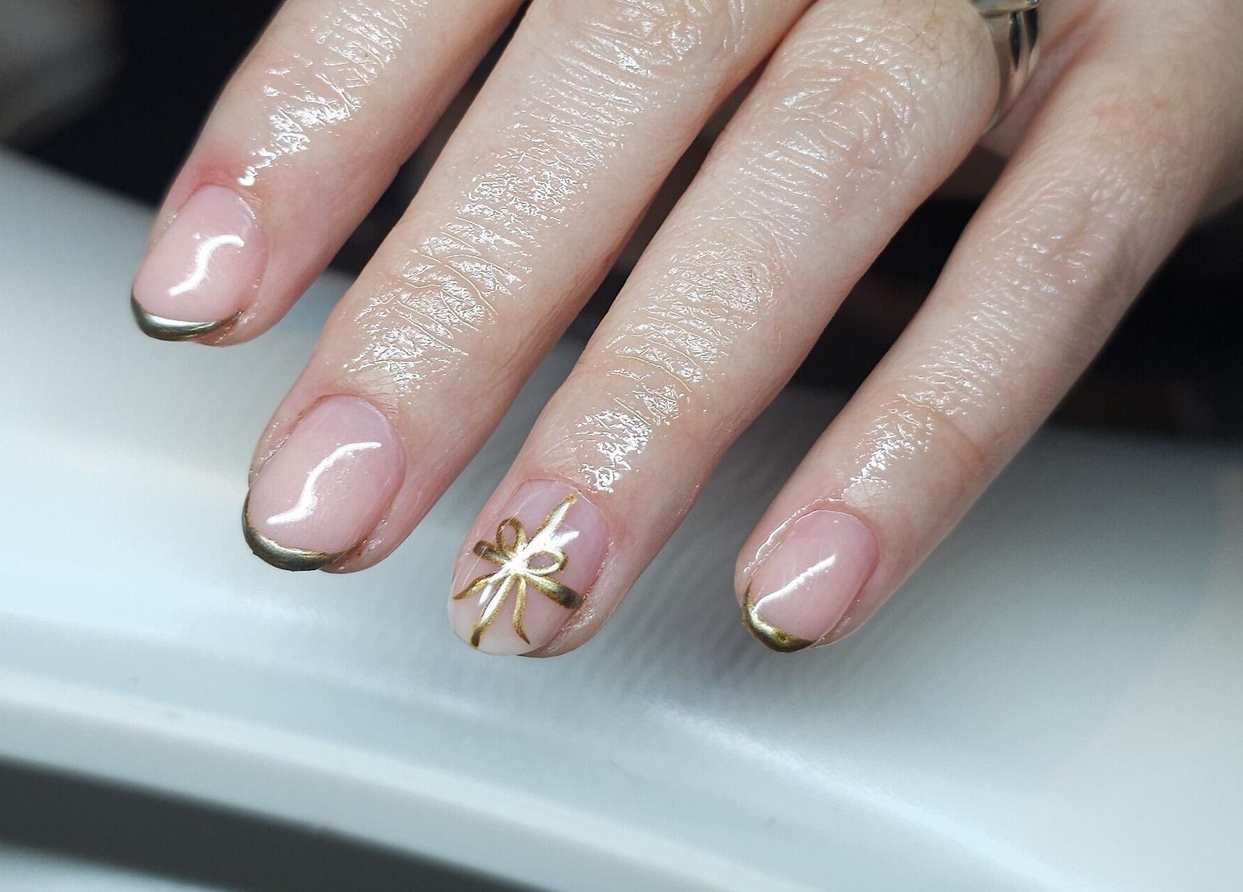 Detailed gold nail art showcased at Glass Skin Studio, Glasgow, Scotland, GB.
