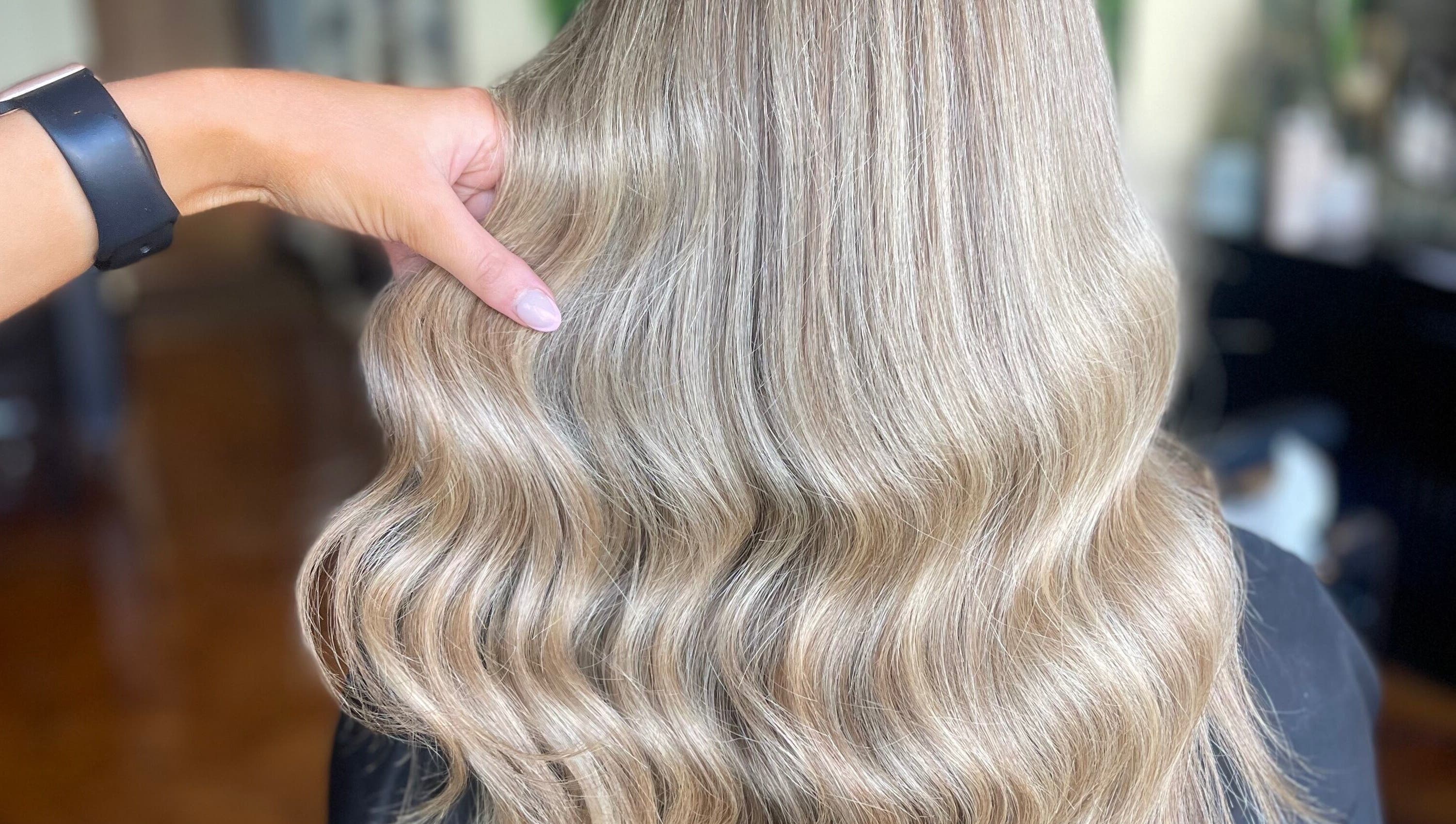 Gleaming blonde waves styled at Fliss Hair, Hindley, England, GB showcasing elegant salon expertise.