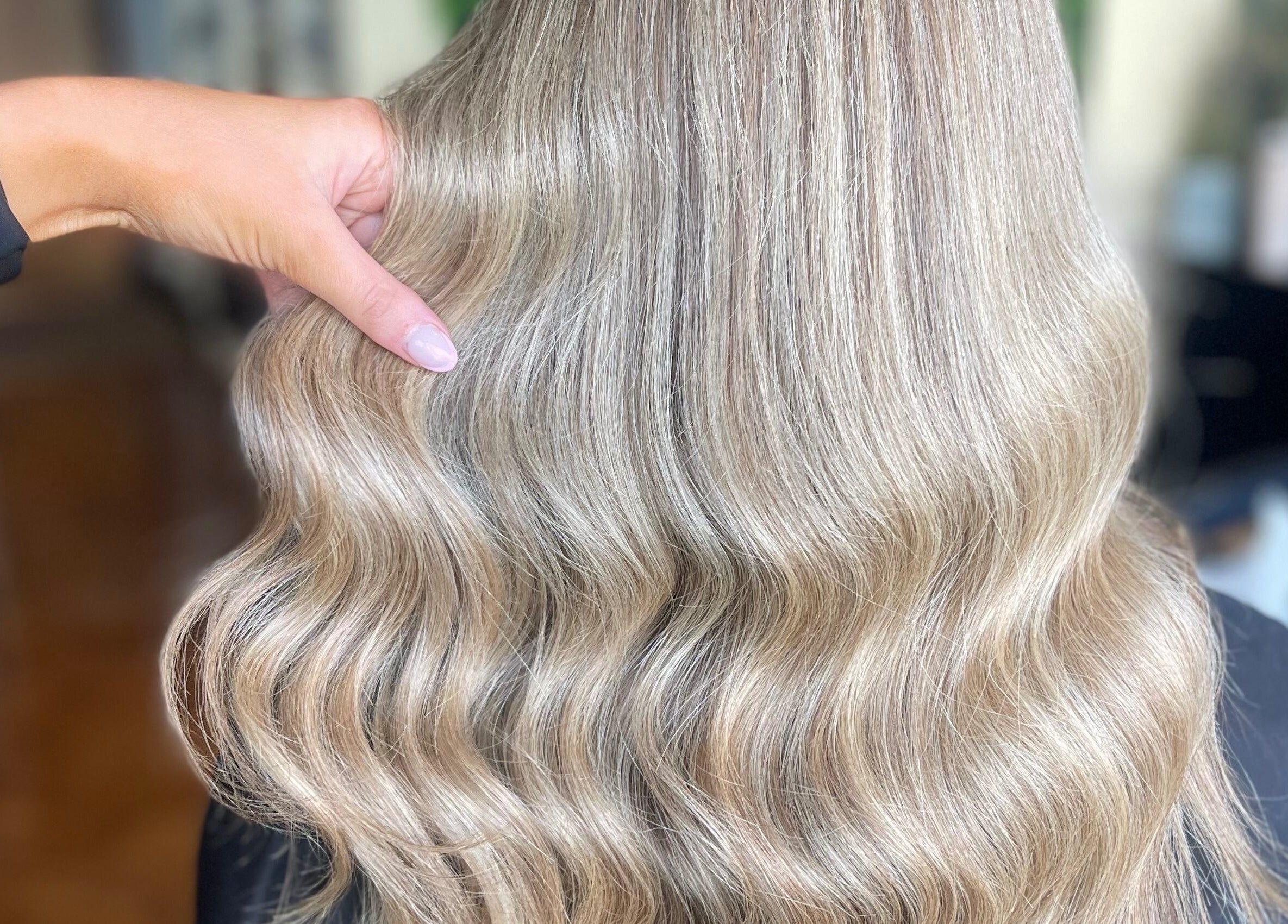 Gleaming blonde waves styled at Fliss Hair, Hindley, England, GB showcasing elegant salon expertise.