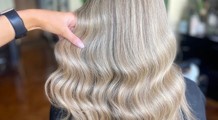 Gleaming blonde waves styled at Fliss Hair, Hindley, England, GB showcasing elegant salon expertise.