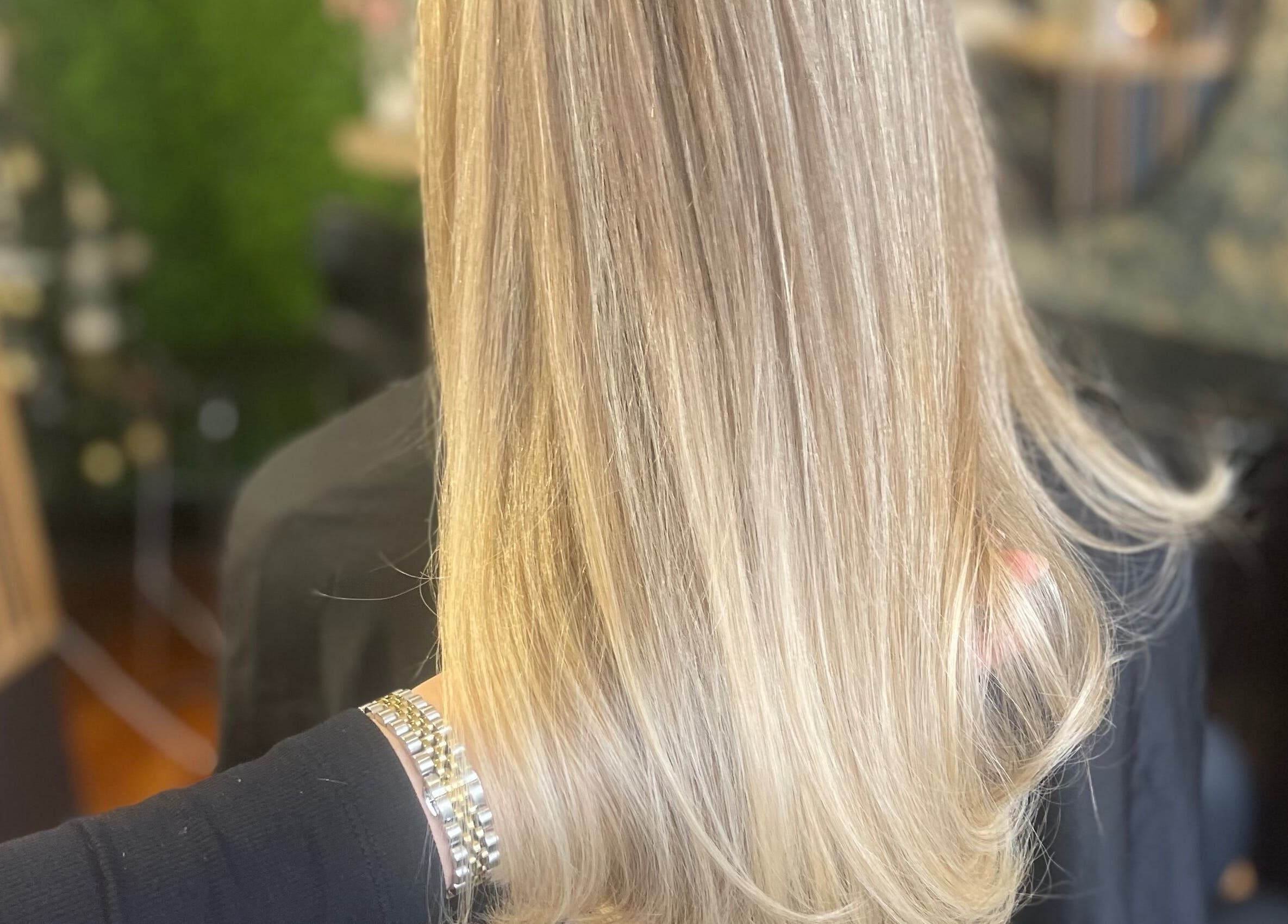 Beautiful blonde hair styled at Fliss Hair, Hindley, England, GB, showcasing silky smoothness and shine.