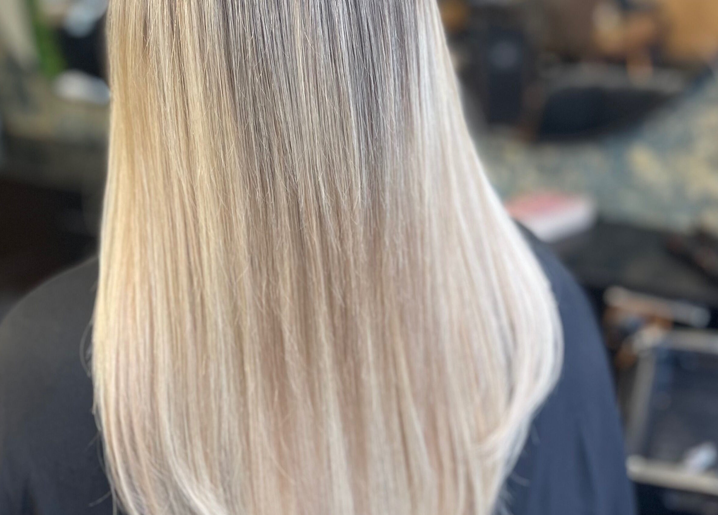 View of sleek, straight blonde hair at Fliss Hair, Hindley, England, GB, showcasing expert styling.