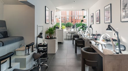 Interior of Salon Mari Chiswick in London, England, GB, featuring modern nail stations and cozy seating.