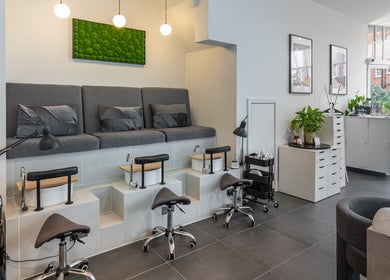 Stylish pedicure area at Salon Mari Chiswick, London, England, GB, featuring cozy seating and modern decor.
