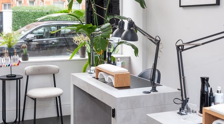 Modern nail station at Salon Mari Chiswick in London, England, GB, featuring sleek decor and greenery.