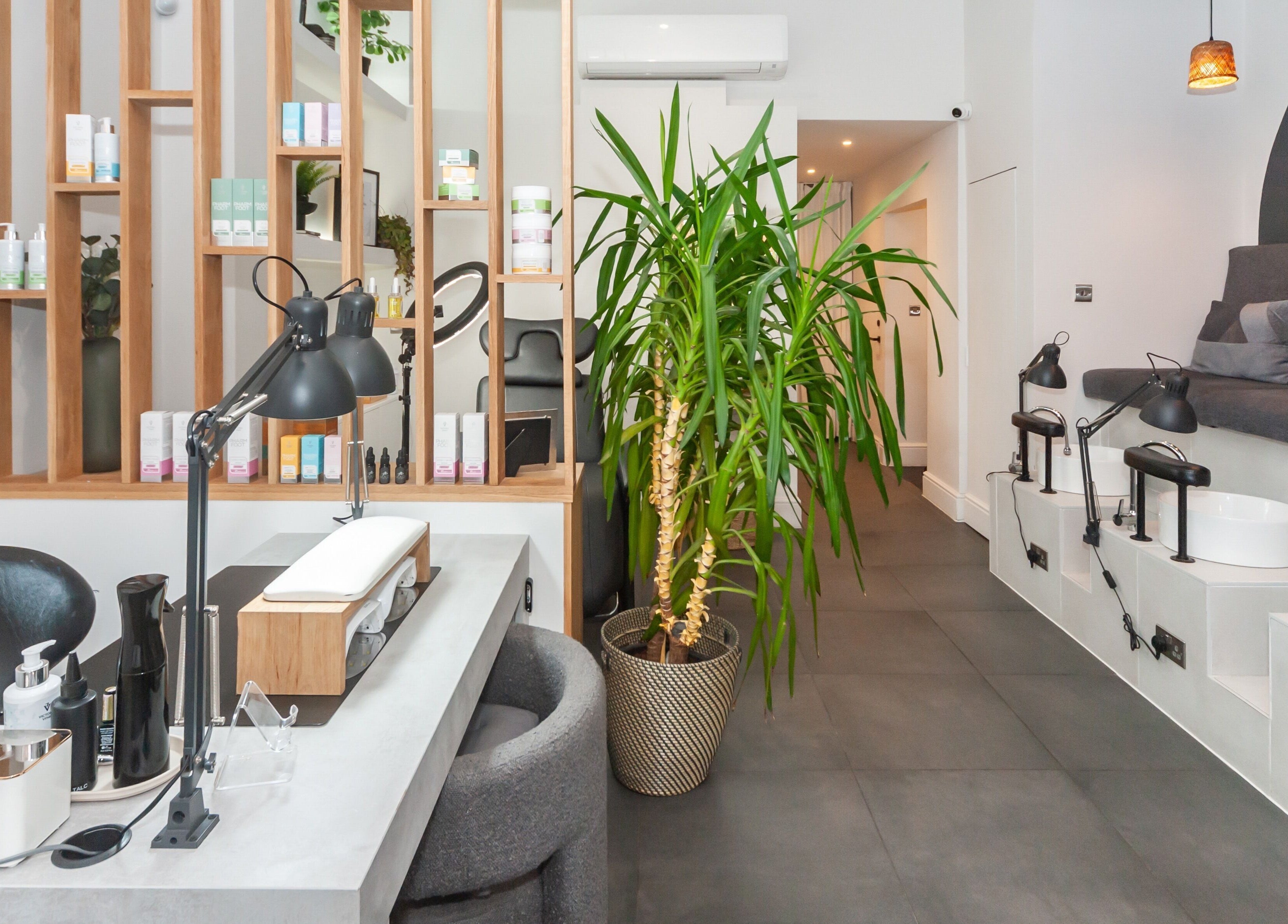 Modern interior of Salon Mari Chiswick, London, England, GB, featuring stylish decor and pedicure stations.