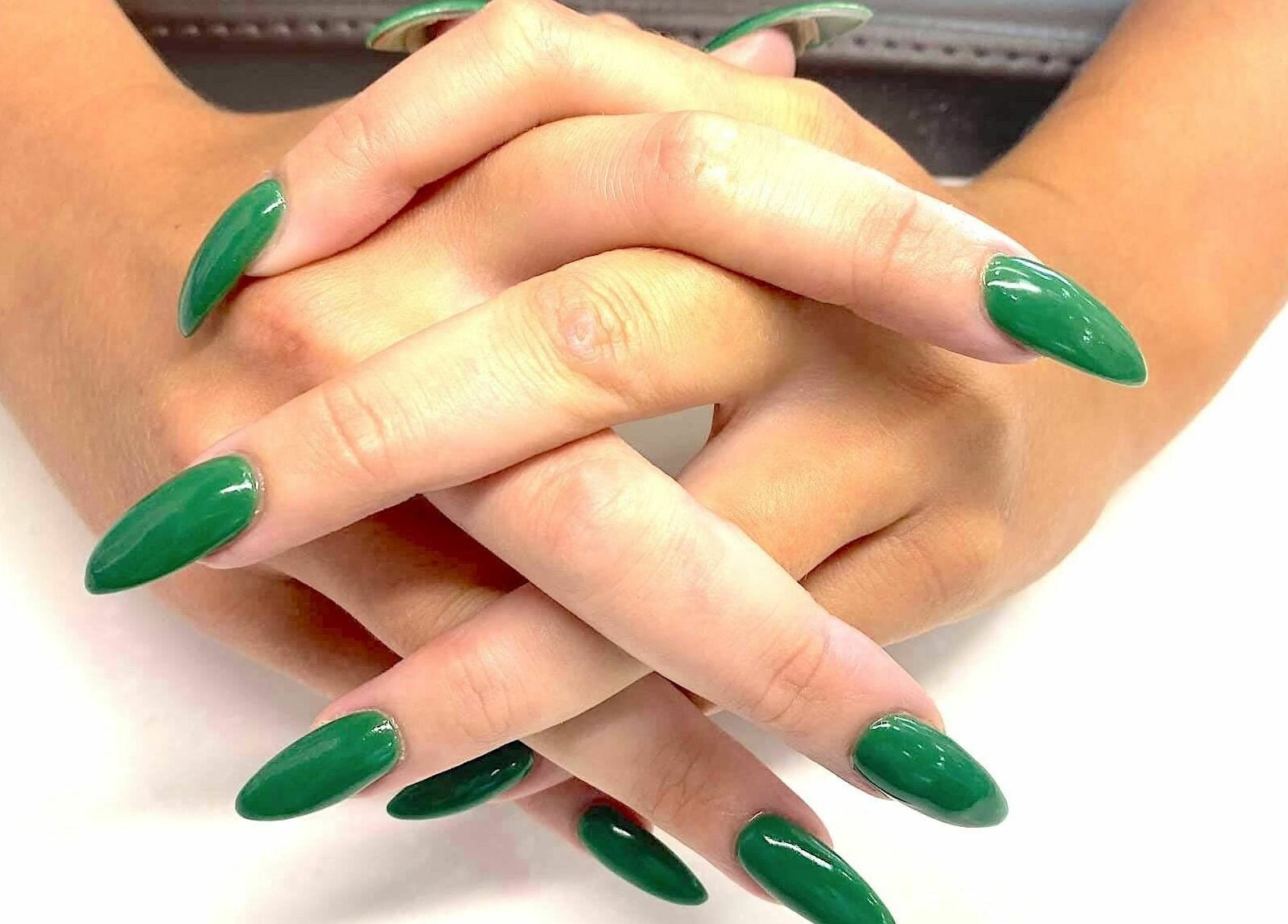 Elegant green manicure at Avalon Nails and Spa in Silver Spring, Maryland, US. Vibrant, polished nails.