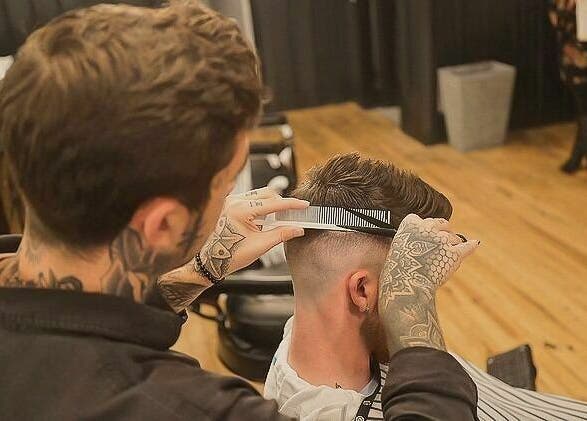 Expert barber crafting modern haircut at Public Square Barbers, Gallatin, Tennessee, US.