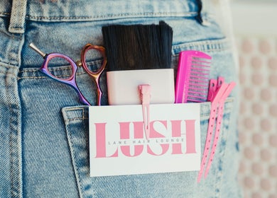 Hair tools in denim pocket at Lush Lane Hair Lounge, Bunbury, WA, AU. Scissors, comb, brush visible.