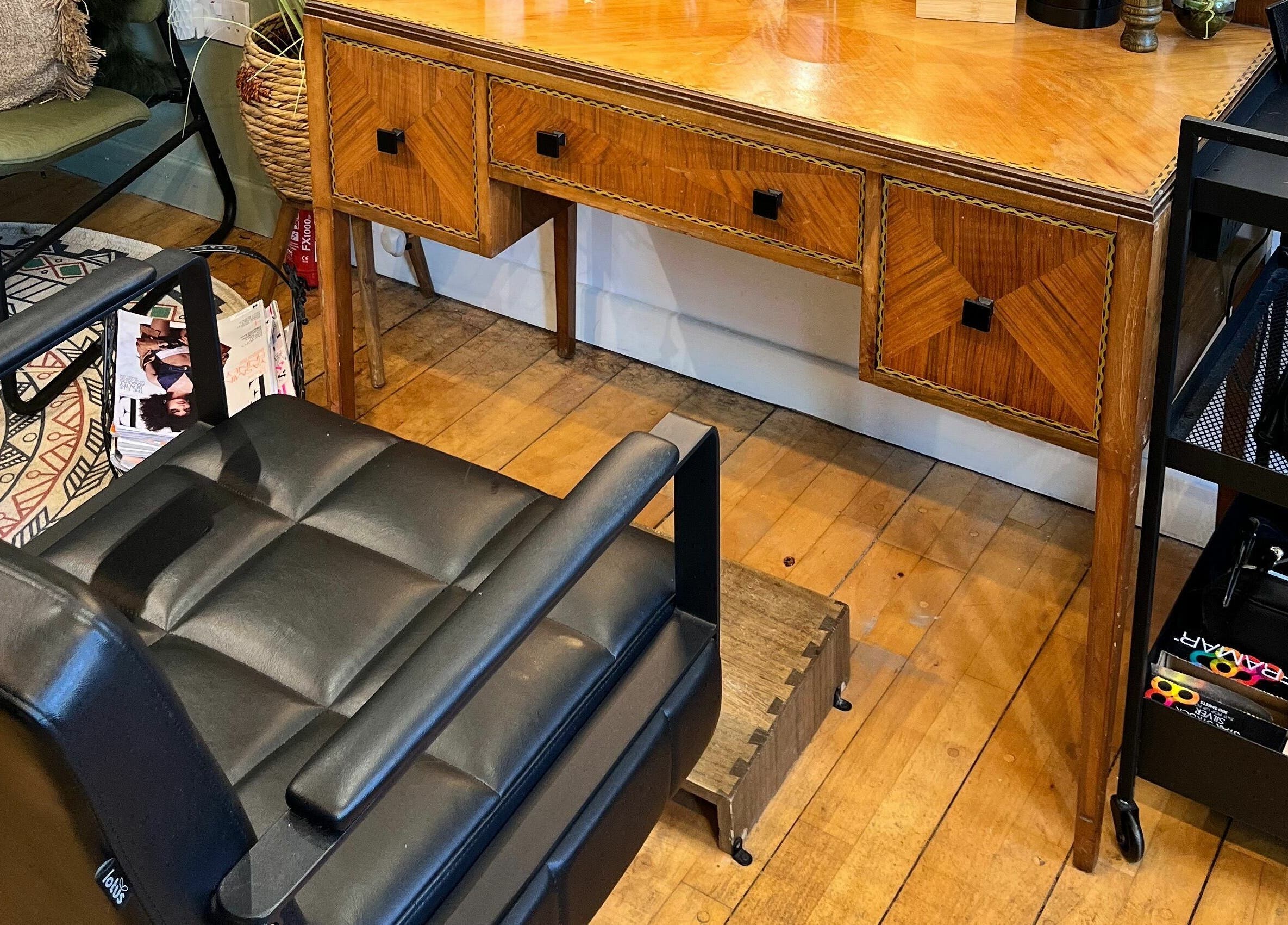 Cozy seating and elegant wooden desk at Sheep Hair, Glasgow, Scotland, GB offering a charming salon experience.